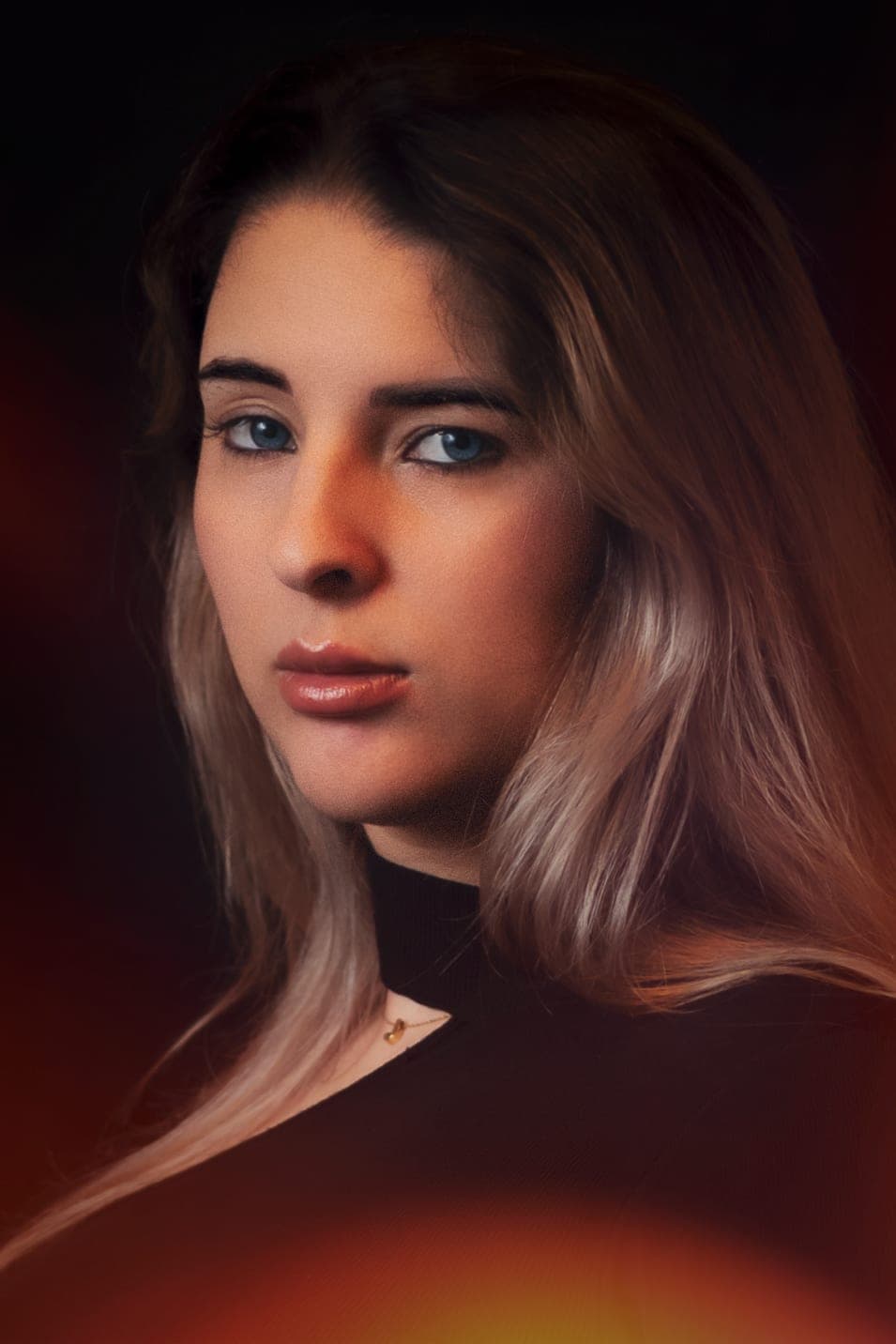 Portrait session: close-up portrait in warm light on a dark background
